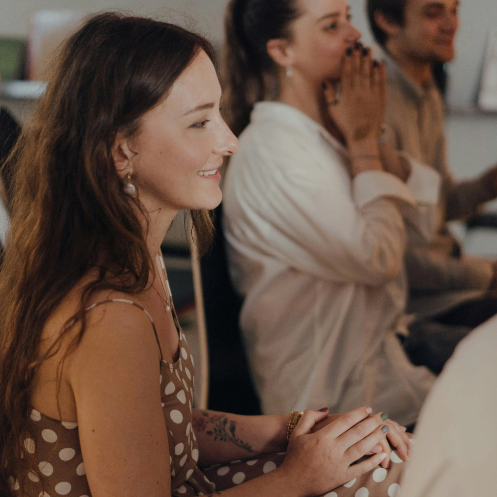 A woman in a dress in a recovery meeting
